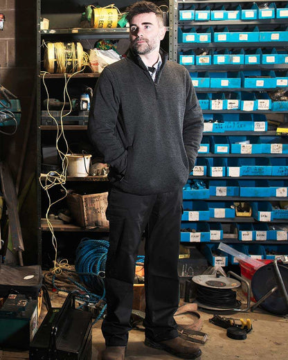 Black Coloured Fort Combat Trousers On A Factory Background 