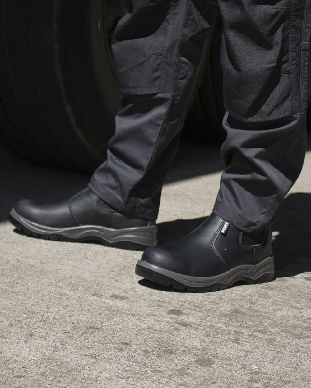 Black Coloured Fort Nelson Safety Dealer Boots On A Street Background 