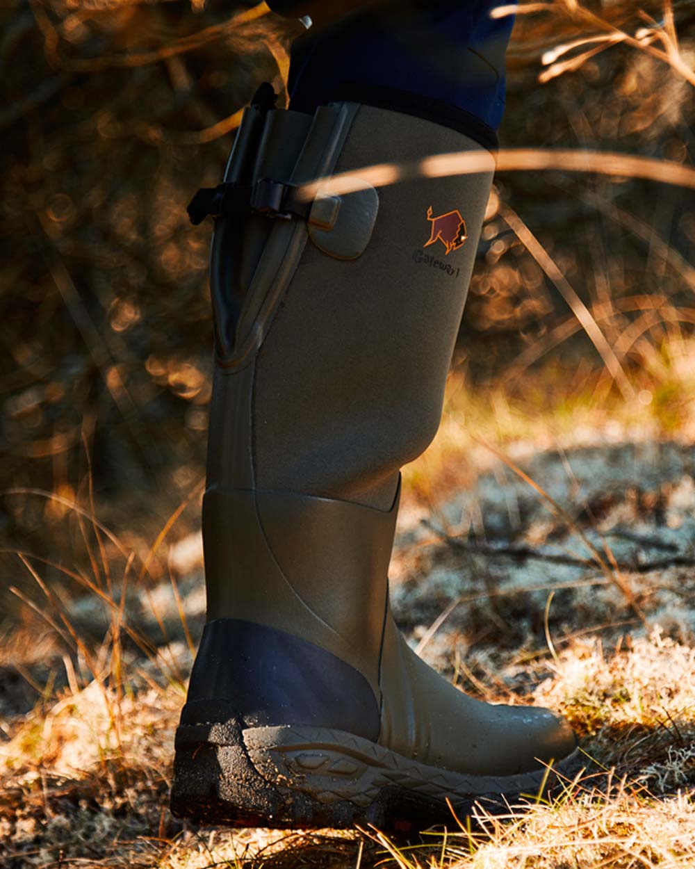 Khaki coloured Gateway1 Woodwalker 18&quot; 4mm Wellingtons on Trail  background 