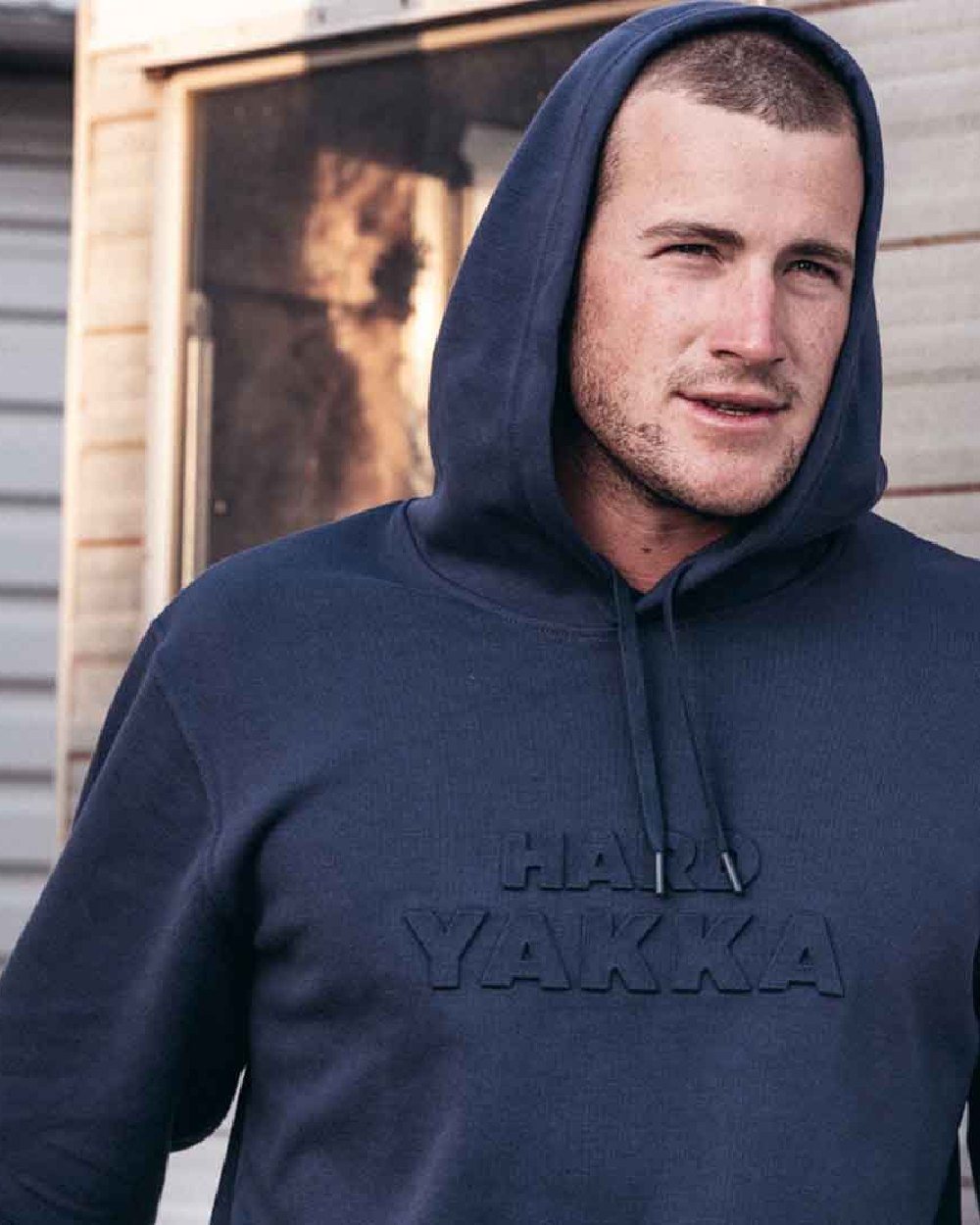 Indigo Coloured Hard Yakka Mens Embossed Pullover Hoodie on Outdoor Background
