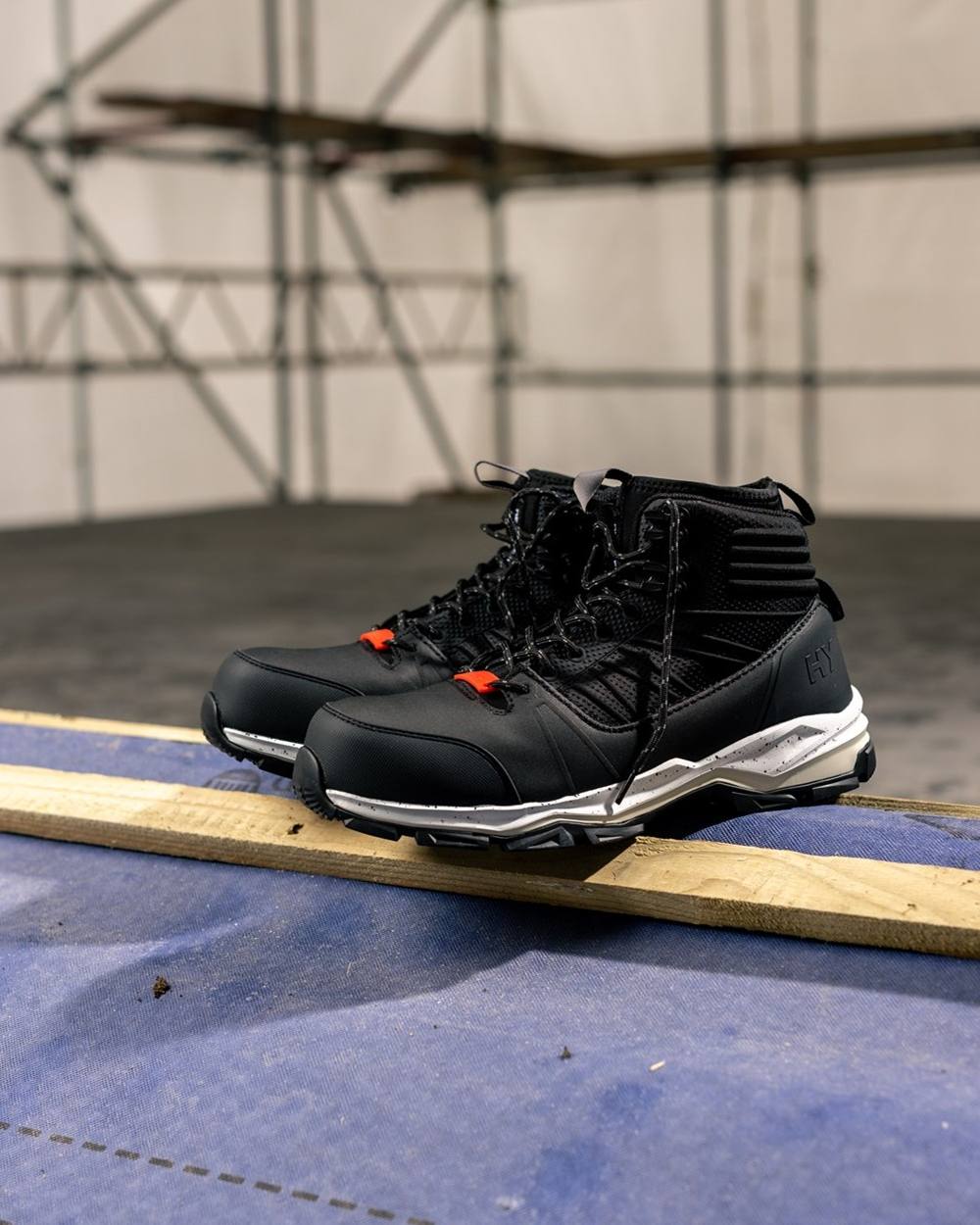 Black Coloured Hard Yakka Mens Neo 2.0 PR Hybrid Side Zip Safety Boots on Indoor Background