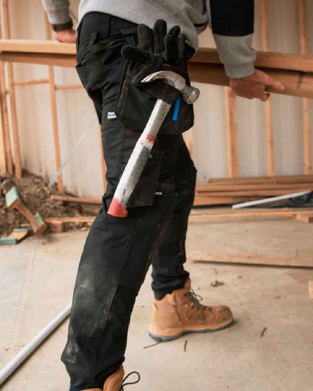 Black Coloured Hard Yakka Mens Raptor Active Trousers on Construction Background
