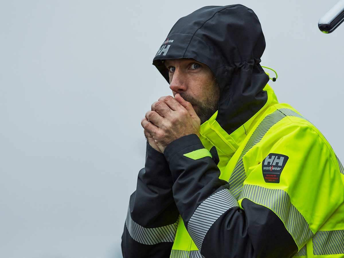 Hi Vis Workear. Man wearing Luminous yellow jacket with hood.