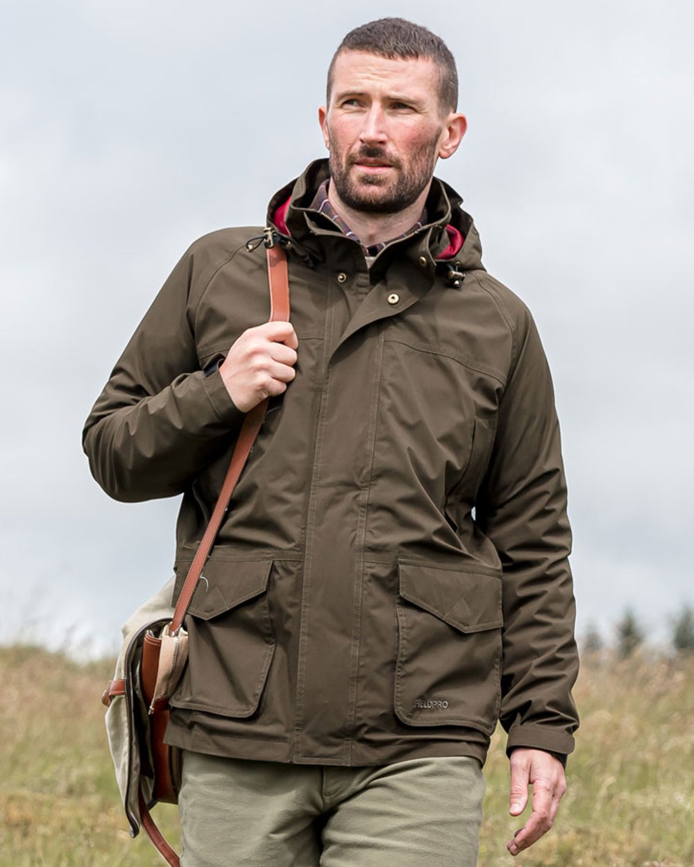 Fern Green coloured Hoggs of Fife Culloden Waterproof Field Jacket on barn background 