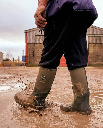 Moss Coloured Muck Boots Arctic Sport Tall Wellingtons On A Shelter Background 