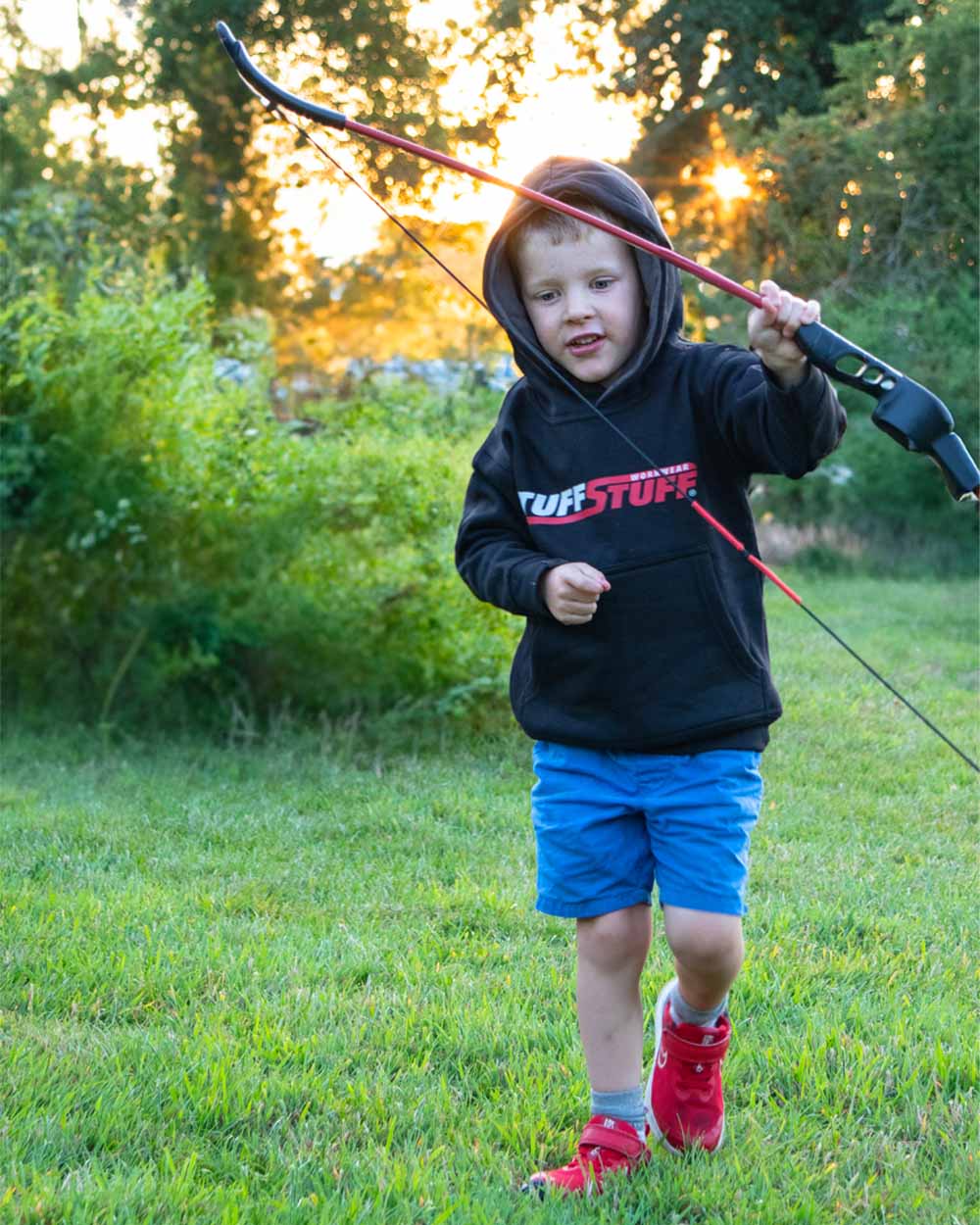 Black coloured TuffStuff Childrens Logo Hoodie on Forest Background 