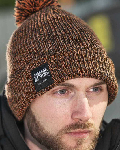 Orange Coloured TuffStuff Elite Bobble Hat On A Farm House Background