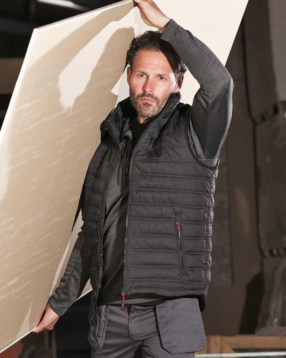 Black Coloured TuffStuff Elite Bodywarmer On A Factory Background