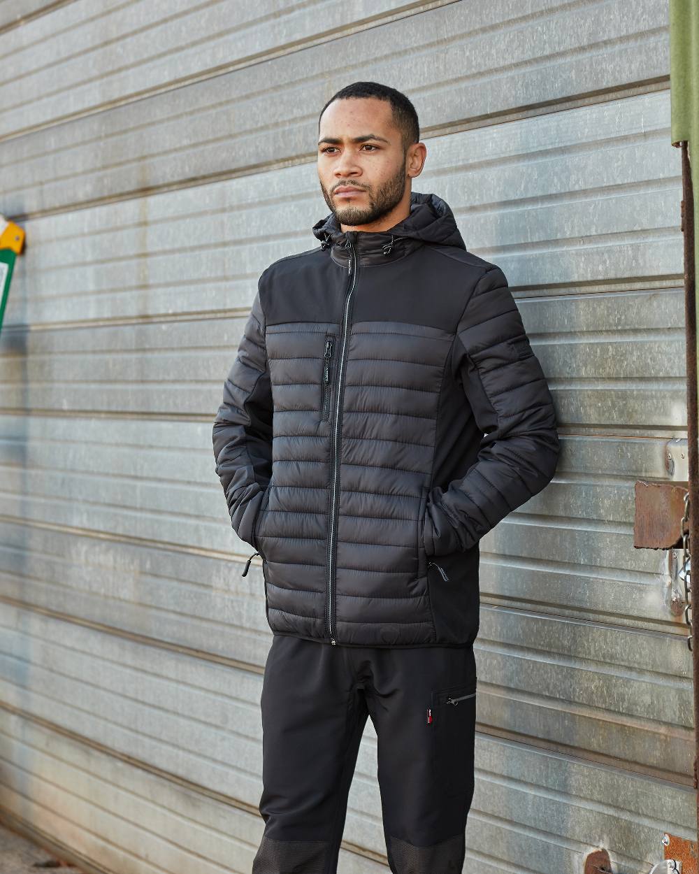 Black Coloured TuffStuff Hatton Soft Shell Jacket On A Warehouse Background