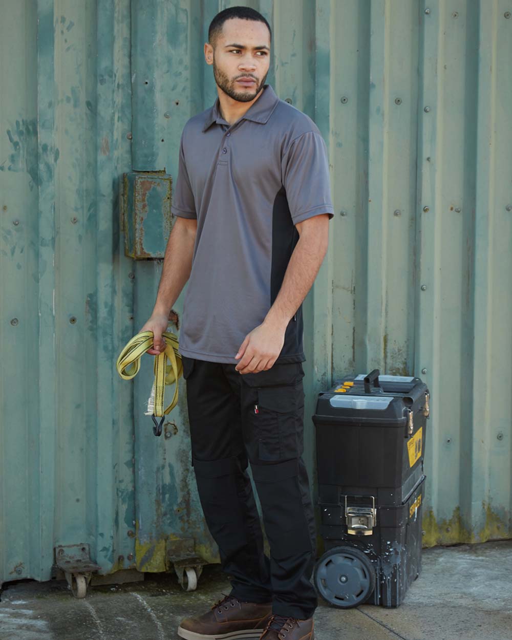 Black coloured TuffStuff ProFlex Work Trousers on Shed Door background 