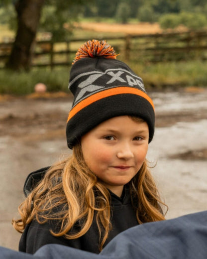Black Coloured Xpert Children Pom Pom Beanie Hat on Outdoor Background
