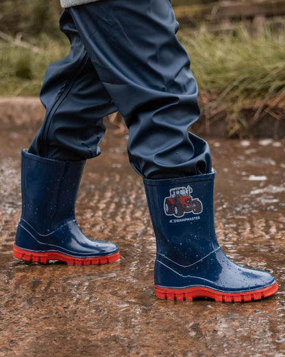 Navy Red Coloured Xpert Childrens Swampmaster Tractor Wellingtons on Outdoor Background
