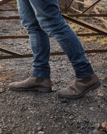 Rustic Brown Coloured Xpert Mens Heritage Saddler Dealer Boots on Outdoor Background
