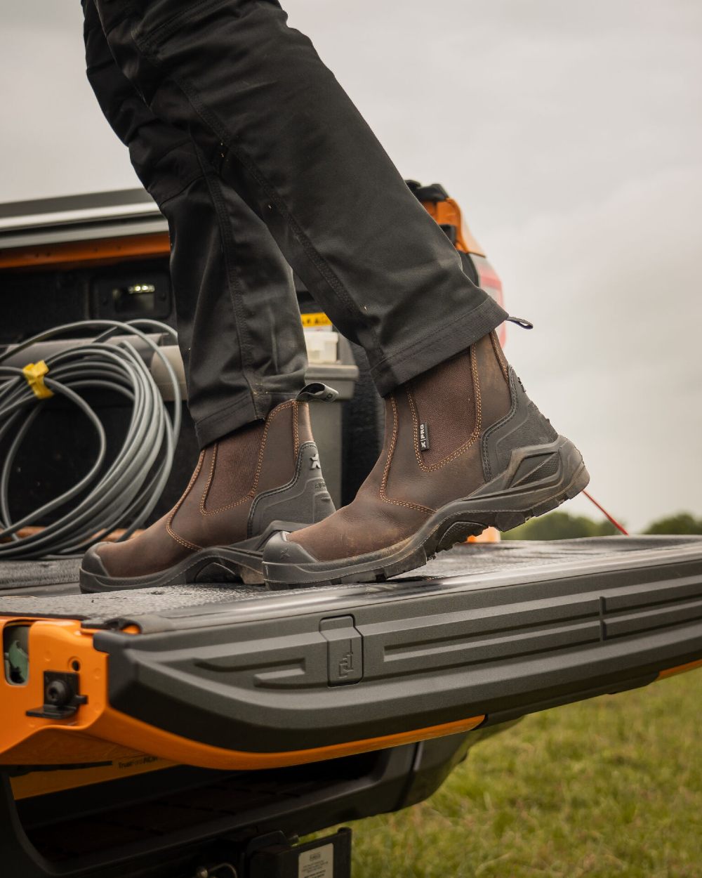 Brown Coloured Xpert Mens Pro Hutton S3L Safety Dealer Boots on Outdoor Background
