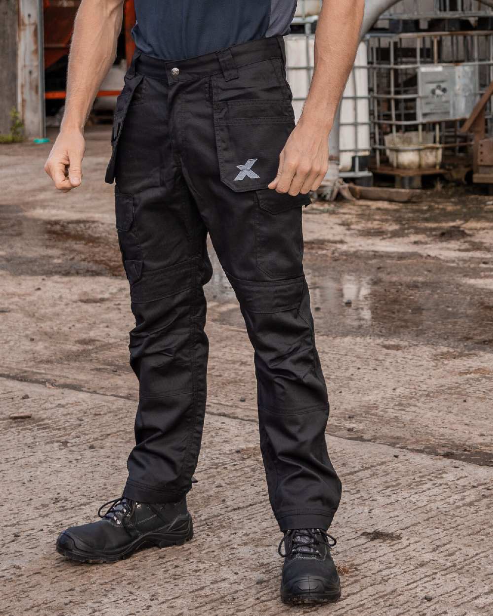 Black Coloured Xpert Mens Pro Stretch Work Trousers on Outdoor Background