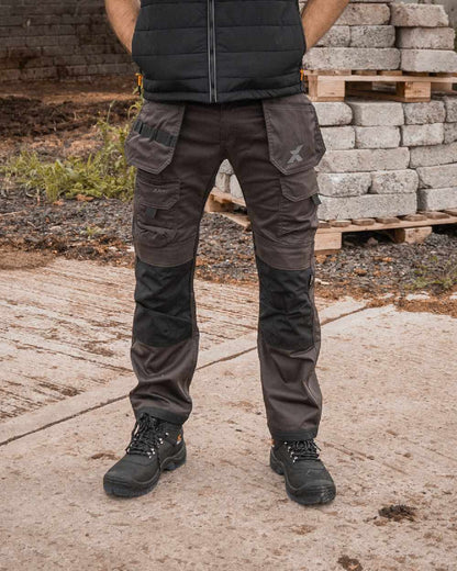 Grey Black Coloured Xpert Mens Pro Stretch Work Trousers on Outdoor Background
