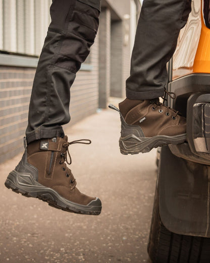 Brown Coloured Xpert Mens Pro Zipster Safety Zip-Side Boots on Outdoor Background
