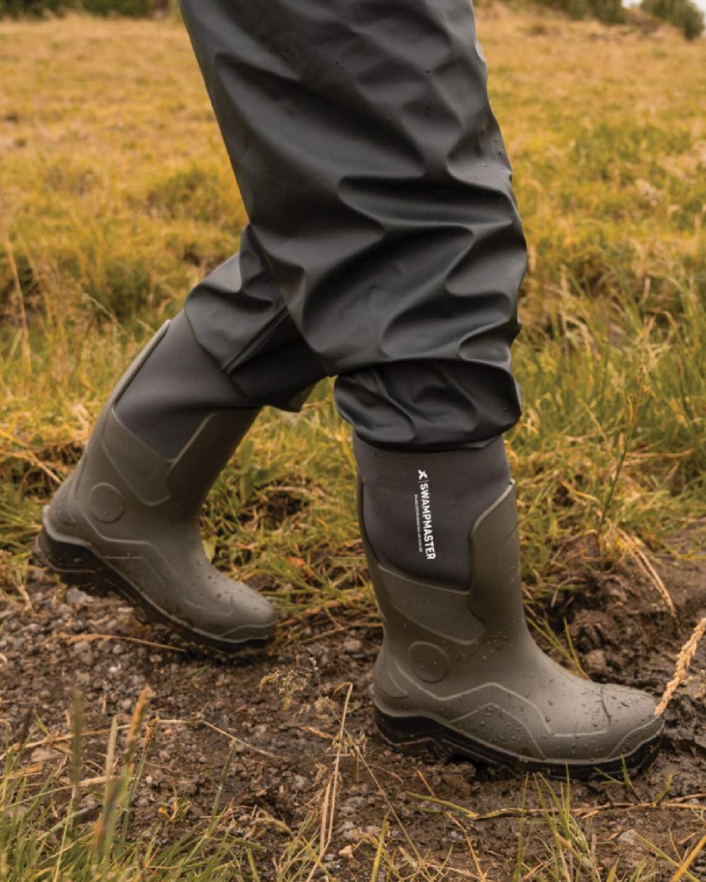Green Coloured Xpert Mens Swampmaster Pro Trapper Wellingtons on field Background
