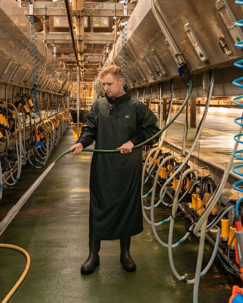 Green Coloured Xpert Swampmaster No-Sweat Stormgear Waterproof Dairy Gown on Factory Background

